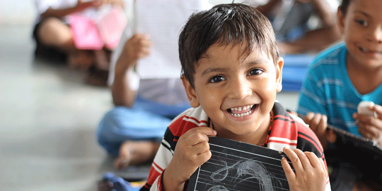 a boy with a small chalkboard