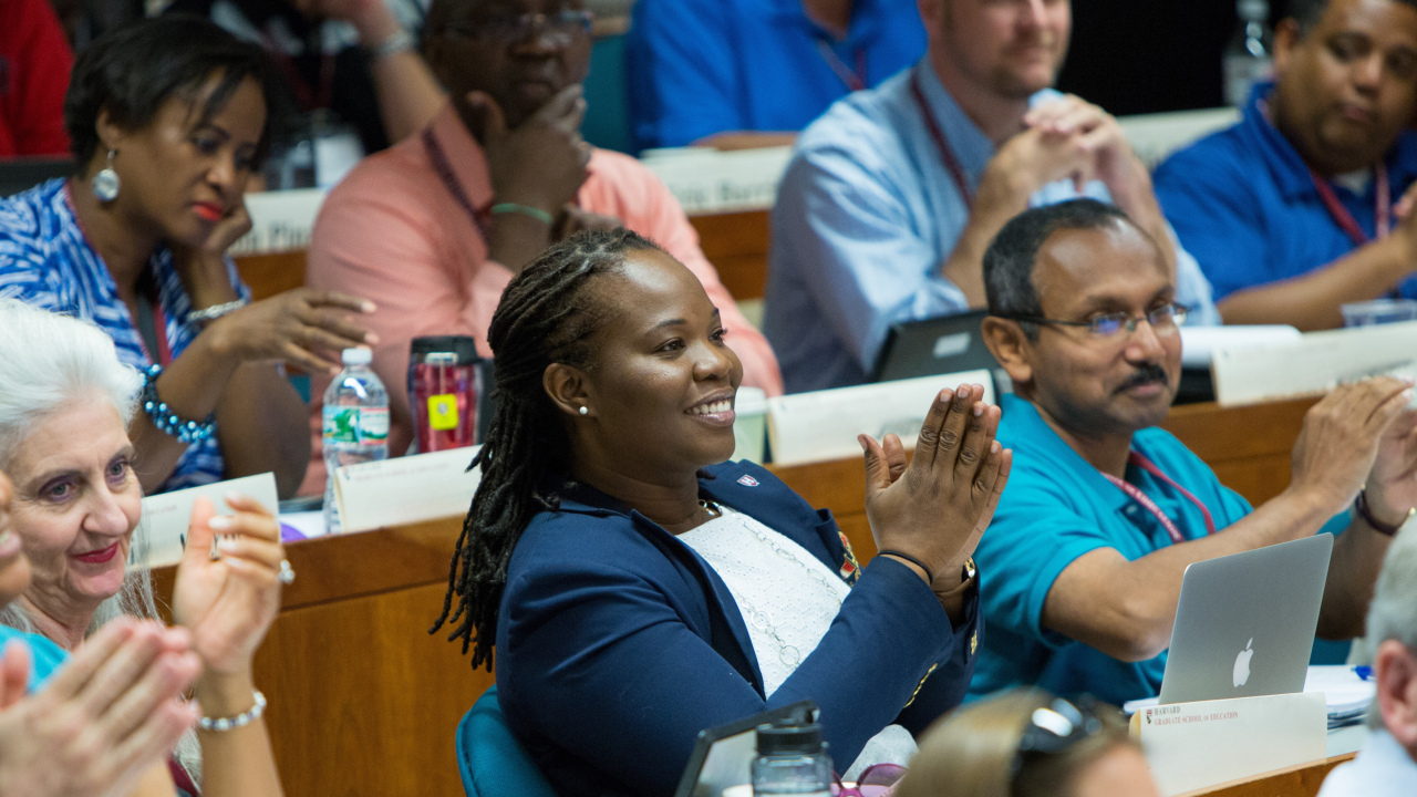 HIHE participants smile and clap during a lecture in Larsen Hall