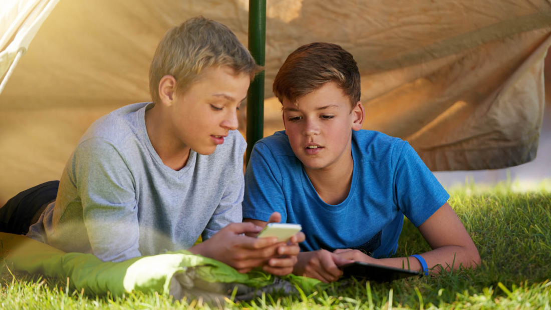 Boys camping with cell phone