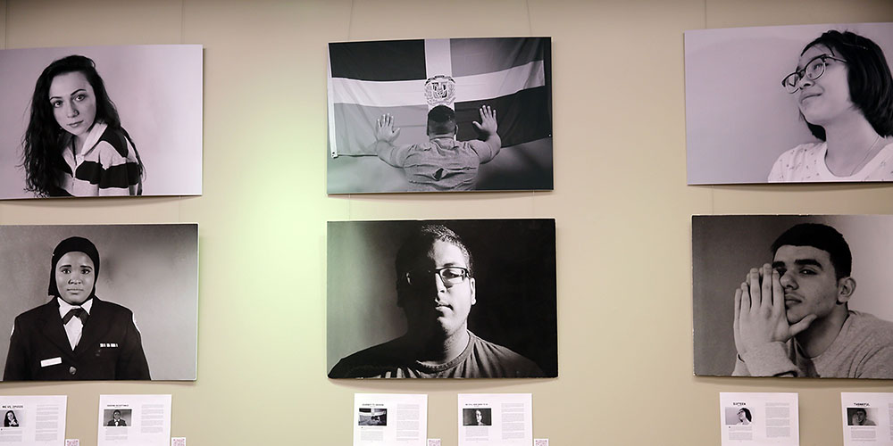 Photos of students on gallery wall