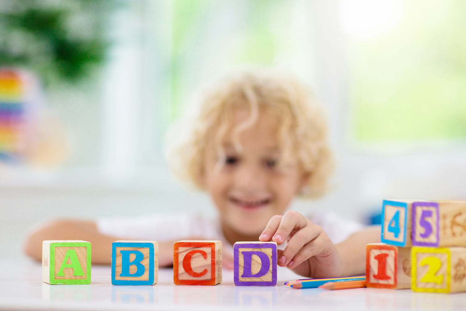 Child playing with wood letter blocks