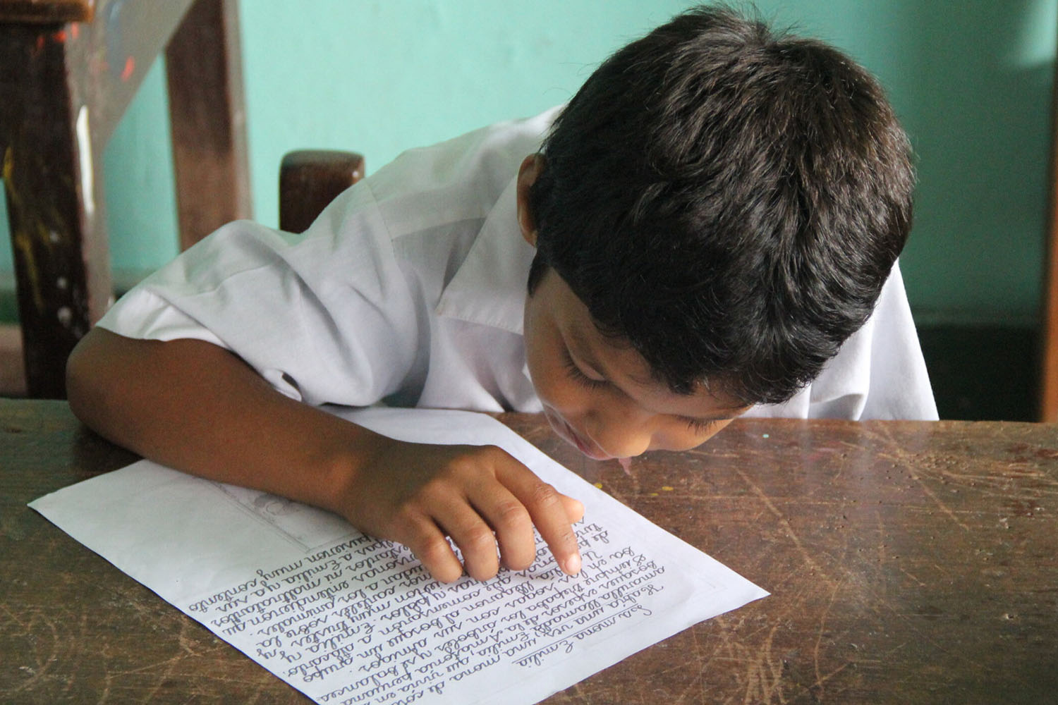 Peruvian student at desk reading