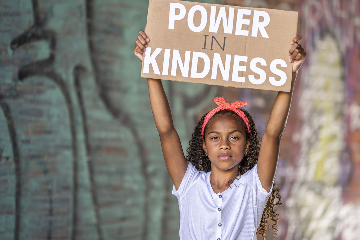 Child with sign - Power is Kindness