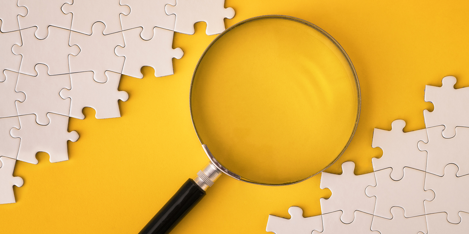 Magnifying glass in the middle of puzzle