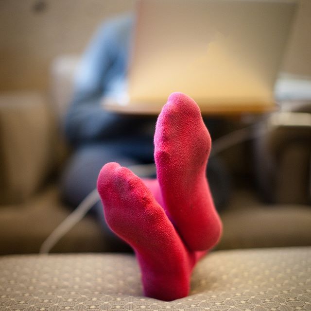 socked feet resting on ottoman