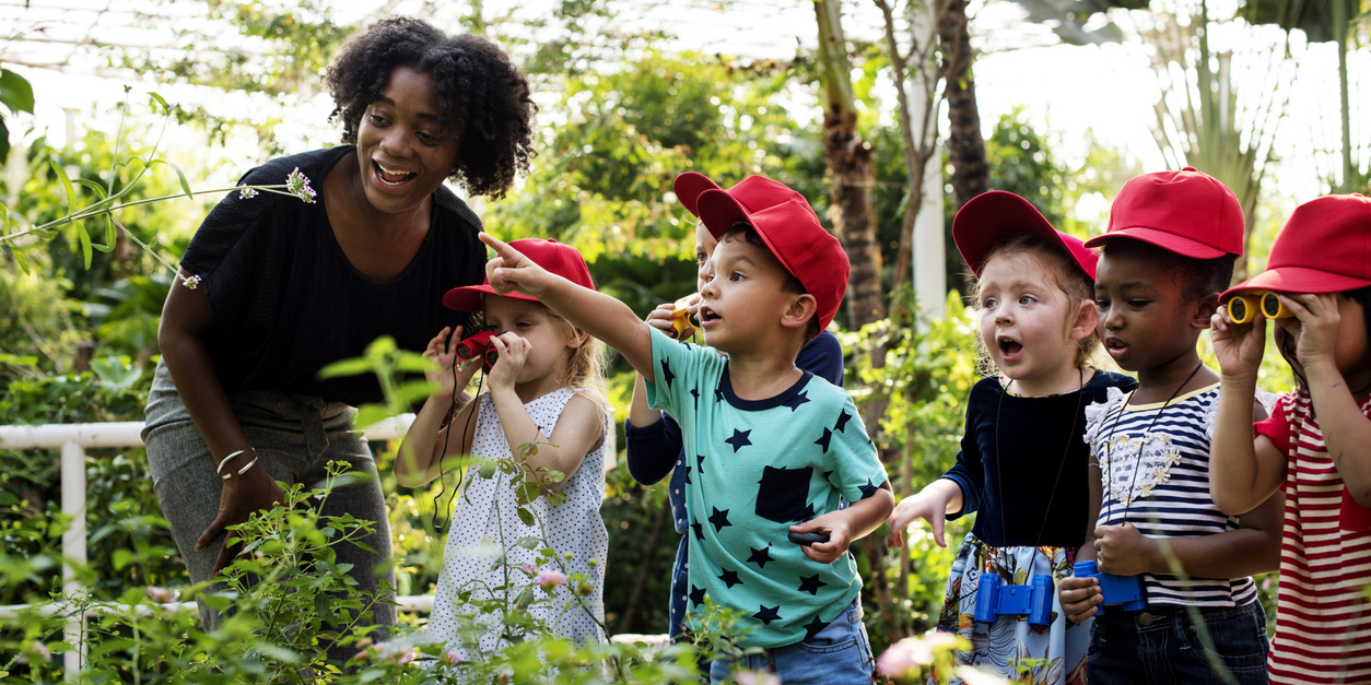 Children with teacher in a greenhouse