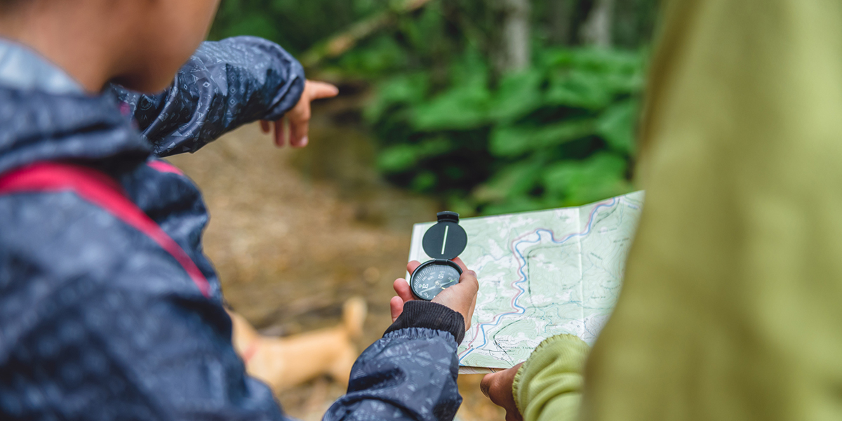 Family hiking with compass