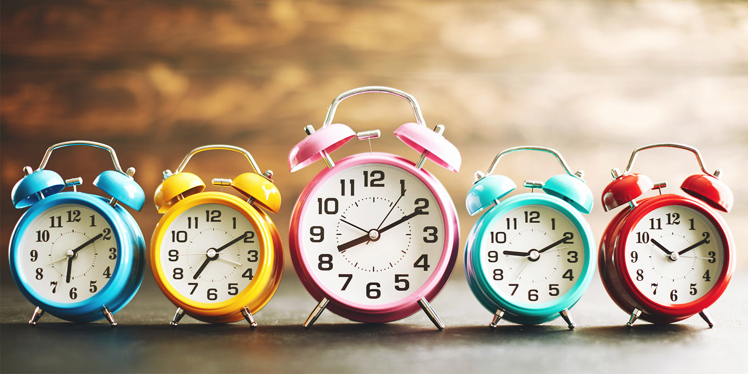 Line of alarm clocks telling different times