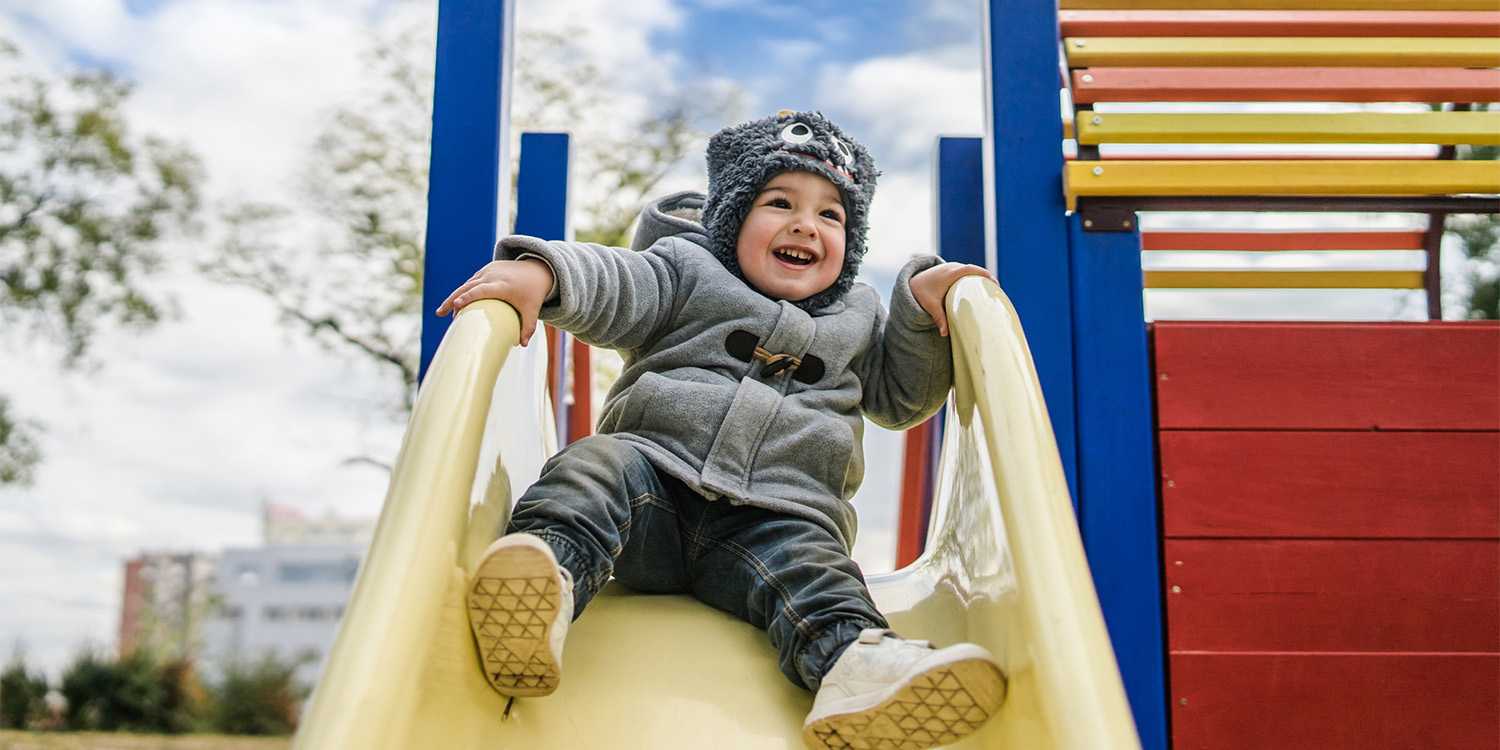 Happy child on playground slide