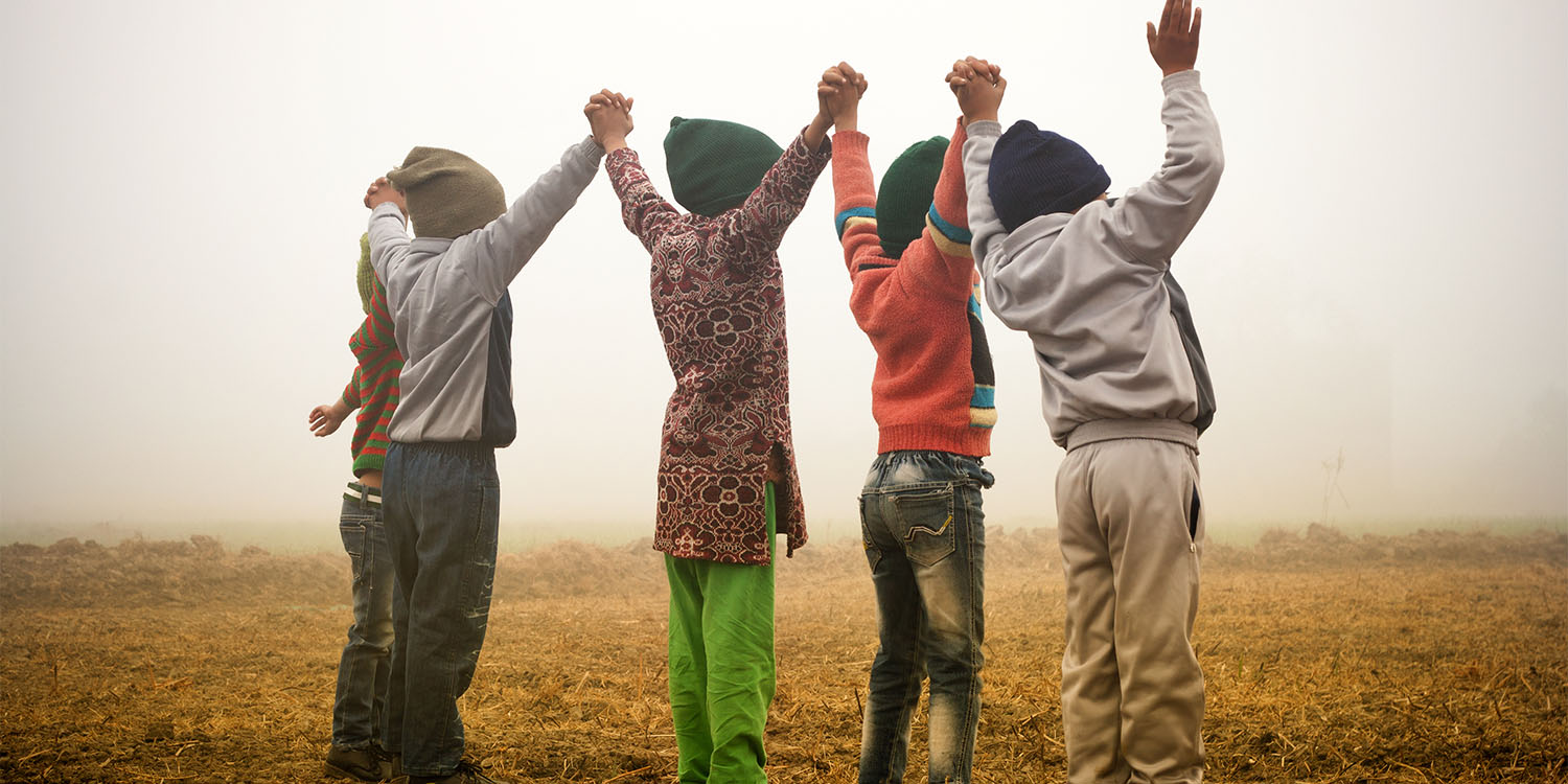 Children standing holding hands