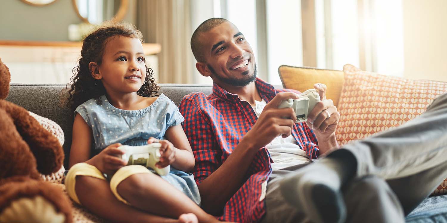 Father and daughter playing video games