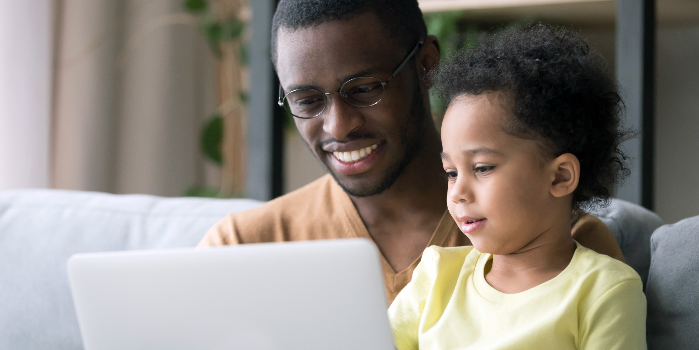 Parent looking at laptop with child