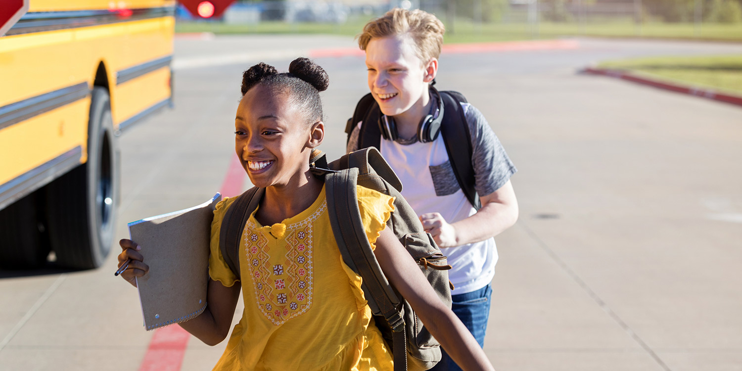 Kids smiling on school bus