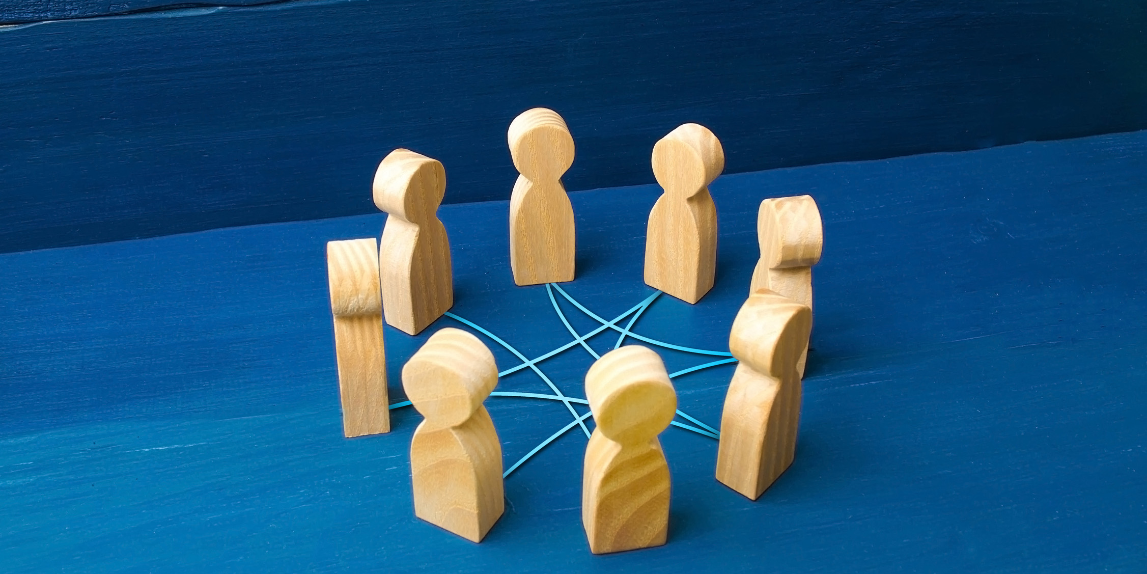 Wood figures in circle connected with string