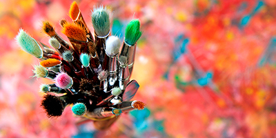 paint brushes against colorful background