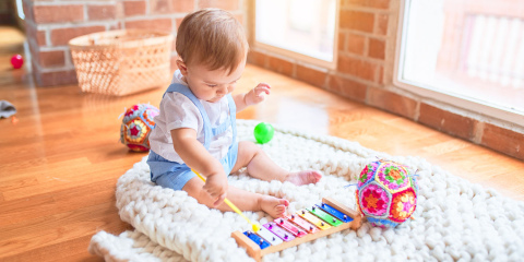 Baby playing musical instrument