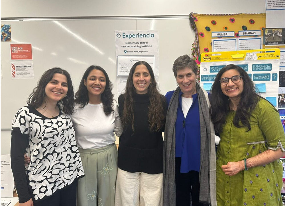 Clari with Lecturer Linda Nathan and other TTL students in a classroom