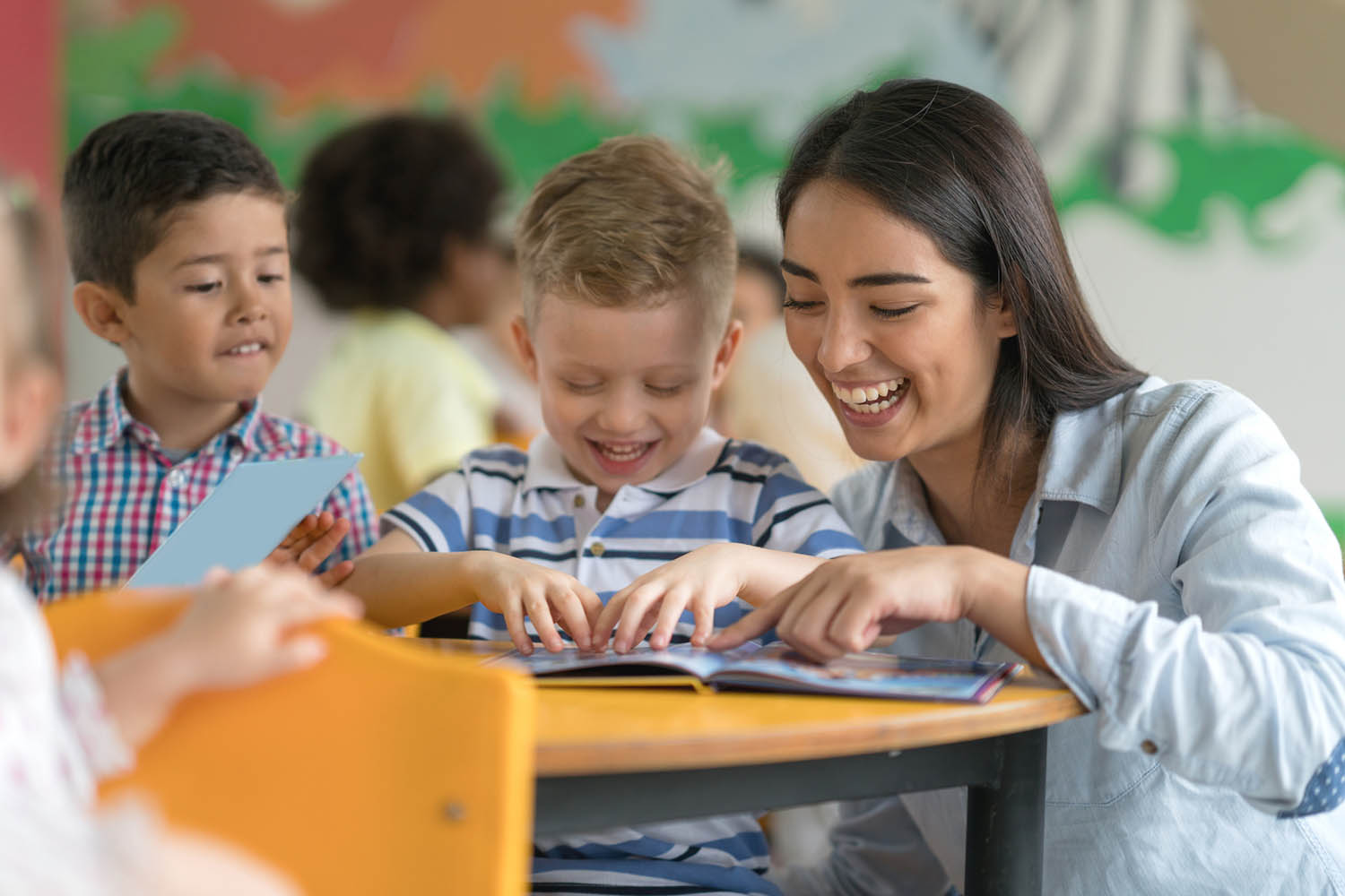 Teacher reading with happy young student