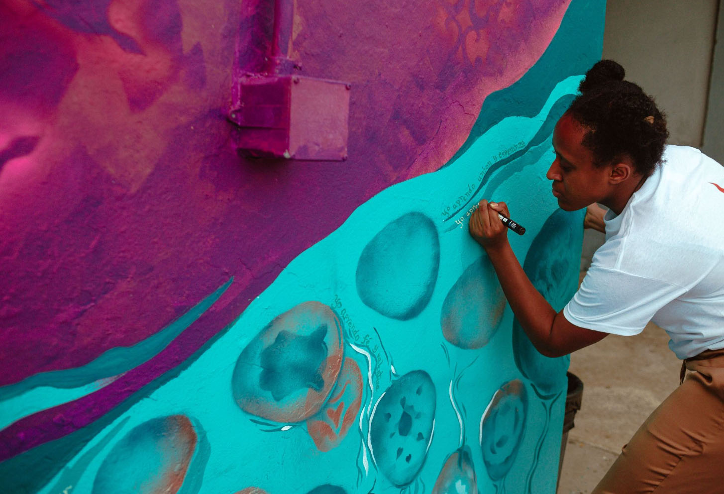 HGSE student working on the mural