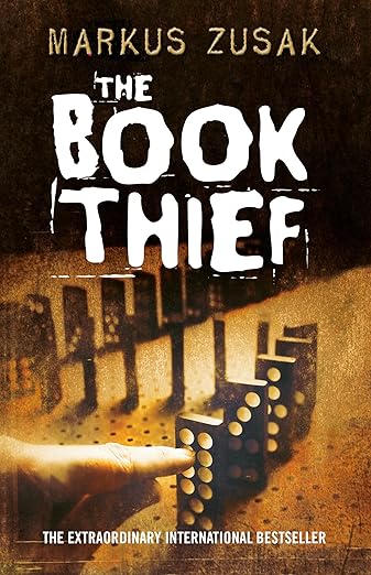 Book cover of "The Book Thief" which features a hand about to push down a row of dominoes