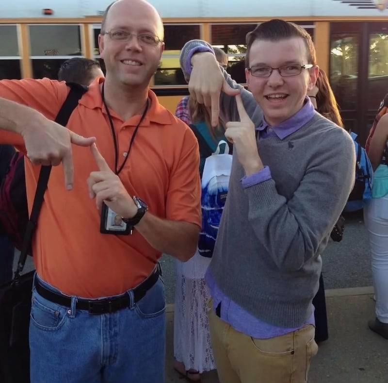 Caleb Miller with his former high school math teacher, Mr. Perkins, making the Pi sign