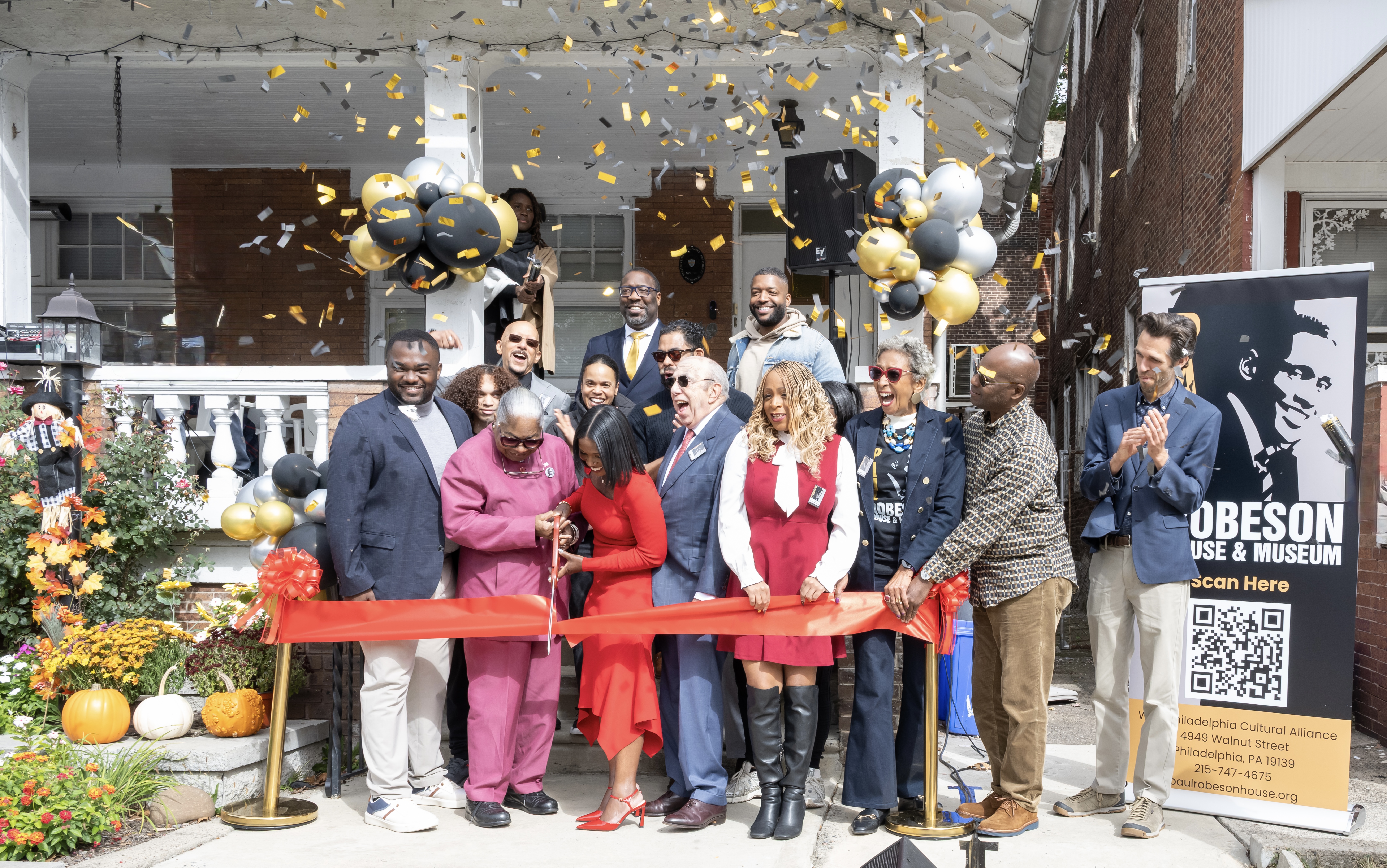 People celebrate at the reopening ceremony of the Robeson House