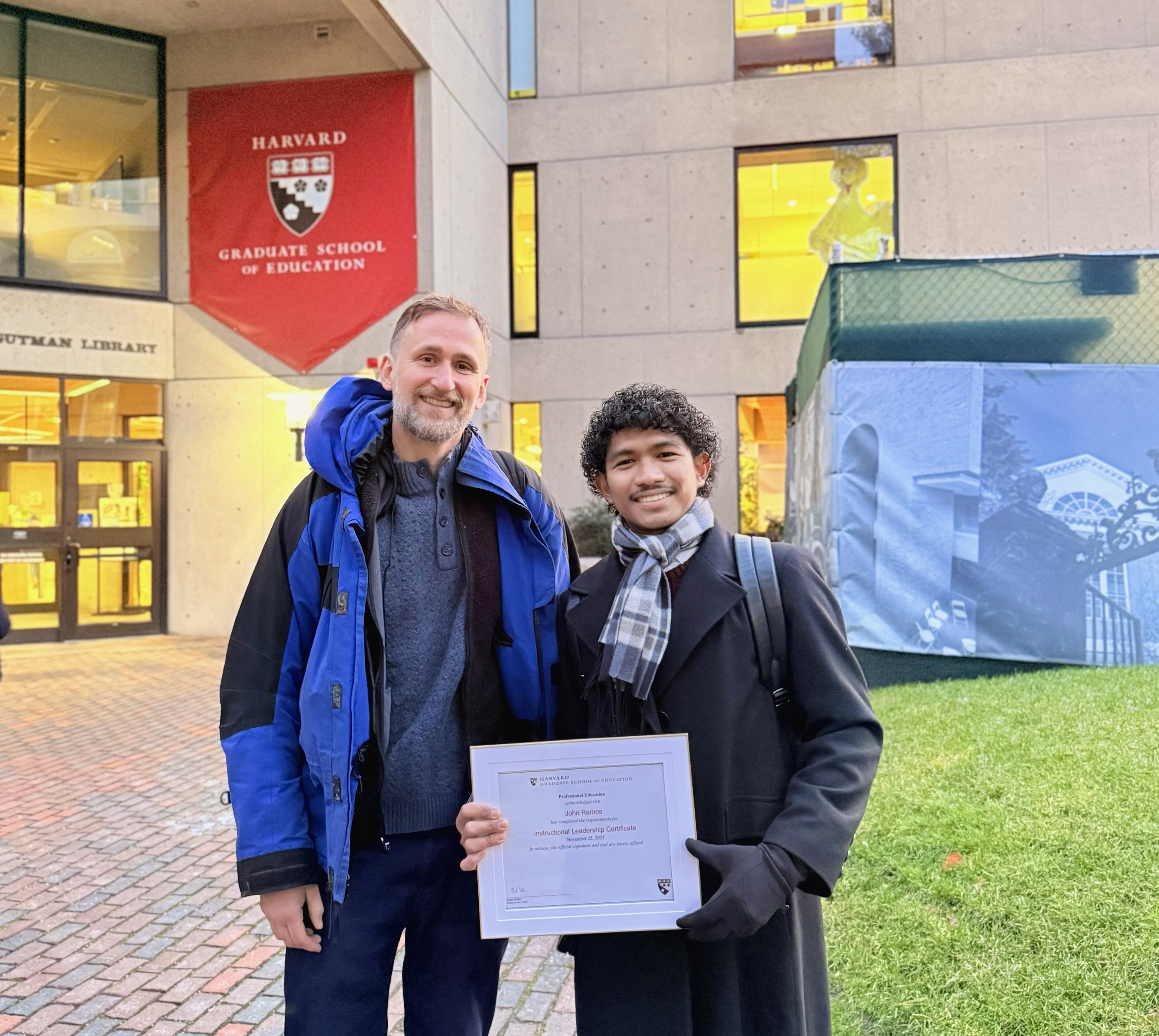 John Ramos receives his certificate outside HGSE's Gutman Library