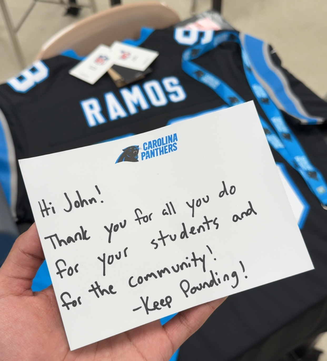 A congratulatory note to John Ramos from the Carolina Panters with a personalized Panthers jersey