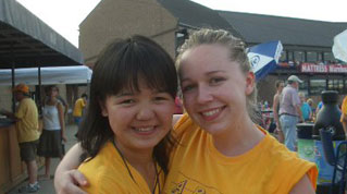 Master's candidate Alyson Gombas (right) with her former student Nargiza at a baseball game when Nargiza visited the U.S.