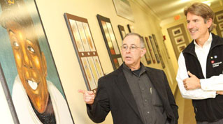 Lecturer Steve Seidel and Ron Berger, Ed.M.'90, view the exhibit of children's artwork in Longfellow Hall