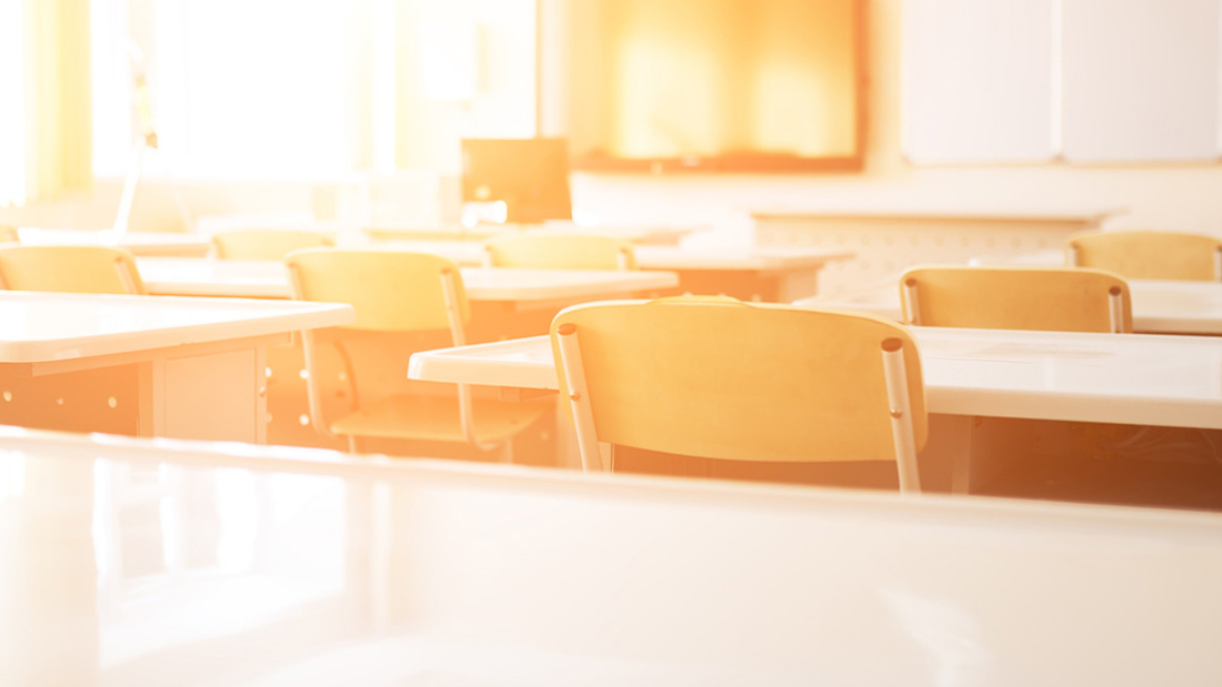 Empty classroom with sun shining in 