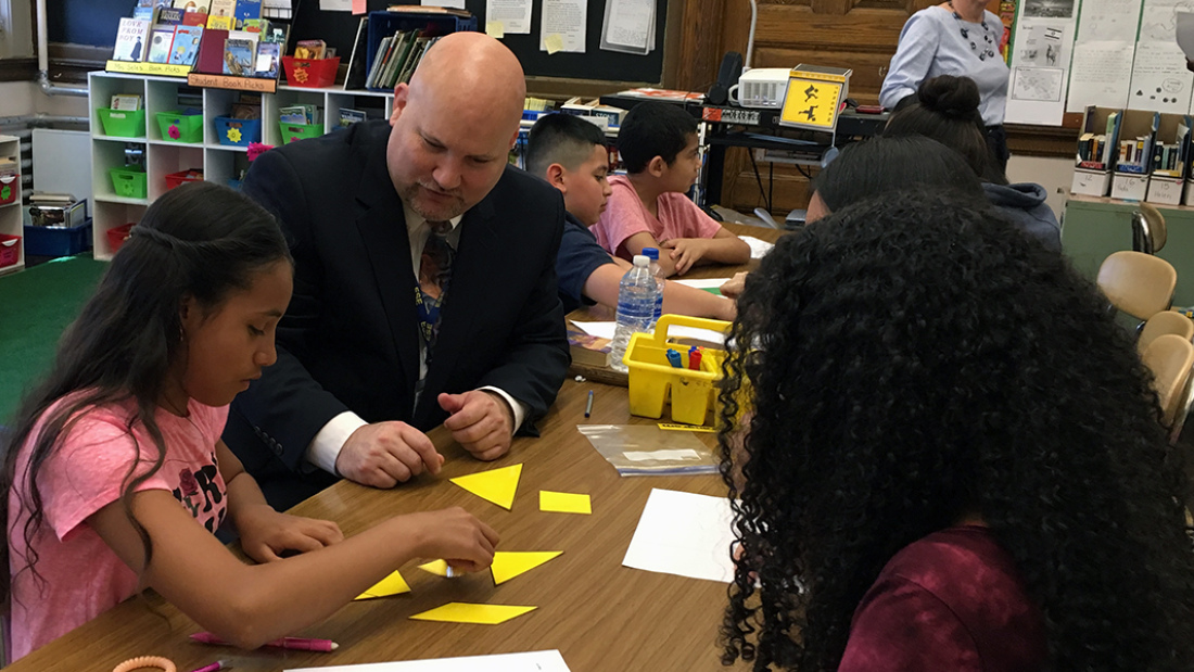 Jeff Riley with students in classroom