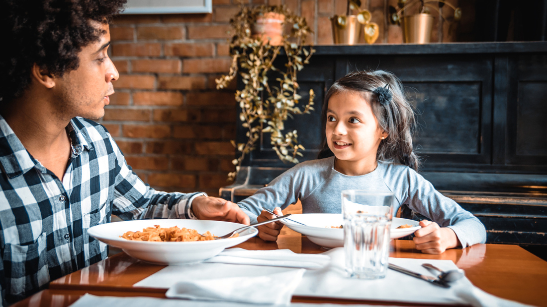 A father having dinner with his daughter