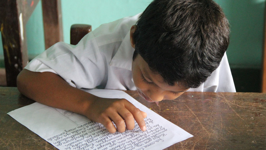 Peruvian student at desk reading