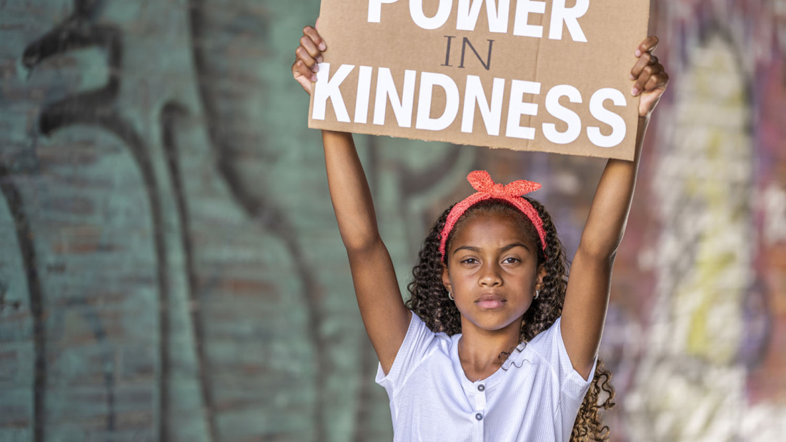 Child with sign - Power is Kindness