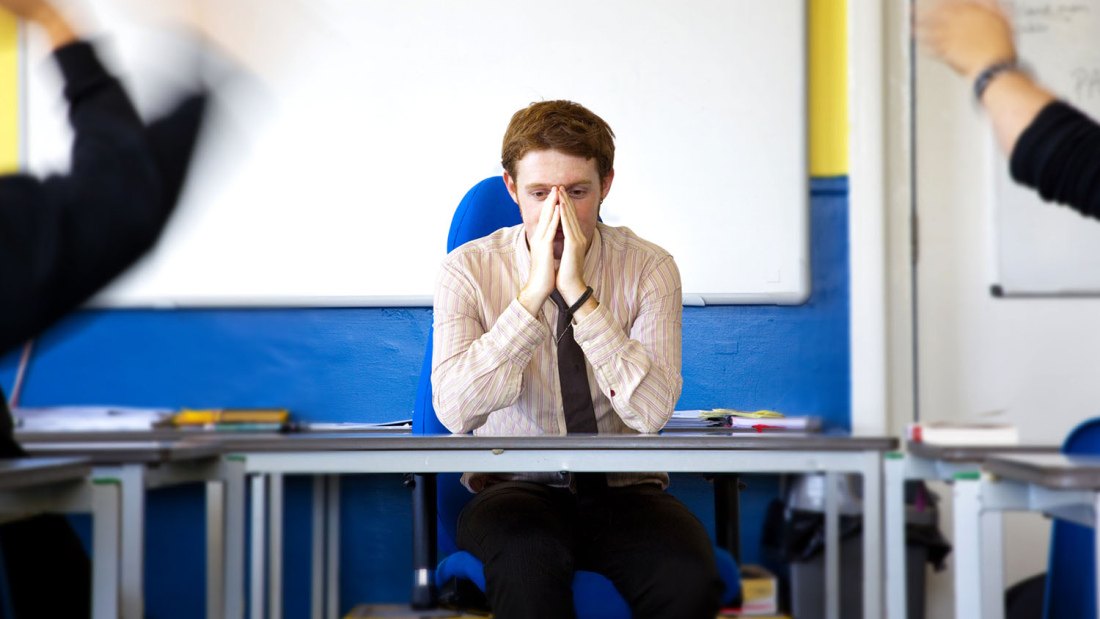 Stressed teacher at desk