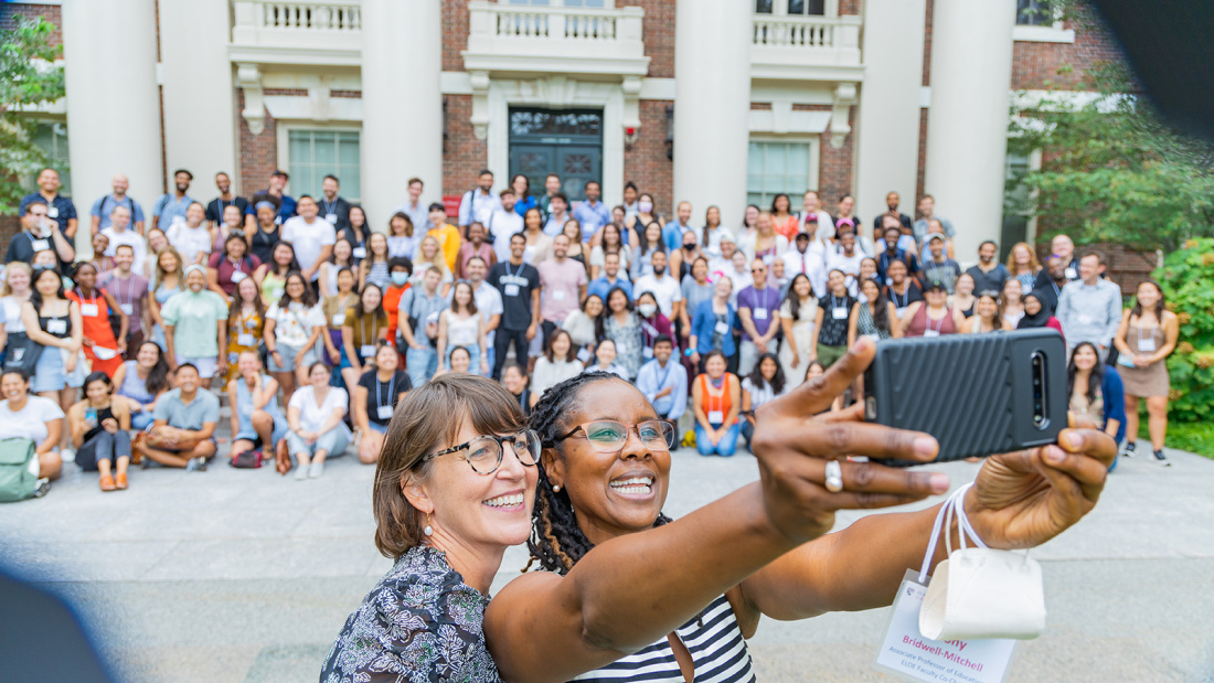 A diverse crowd of HGSE students stand outside for a massive selfie