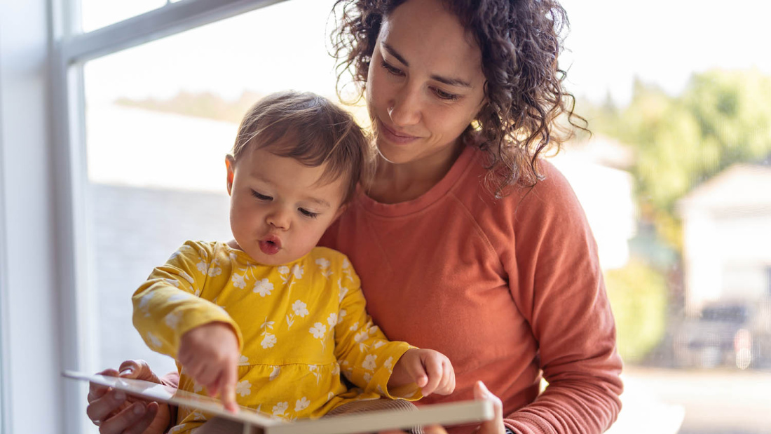 Mother reading with baby