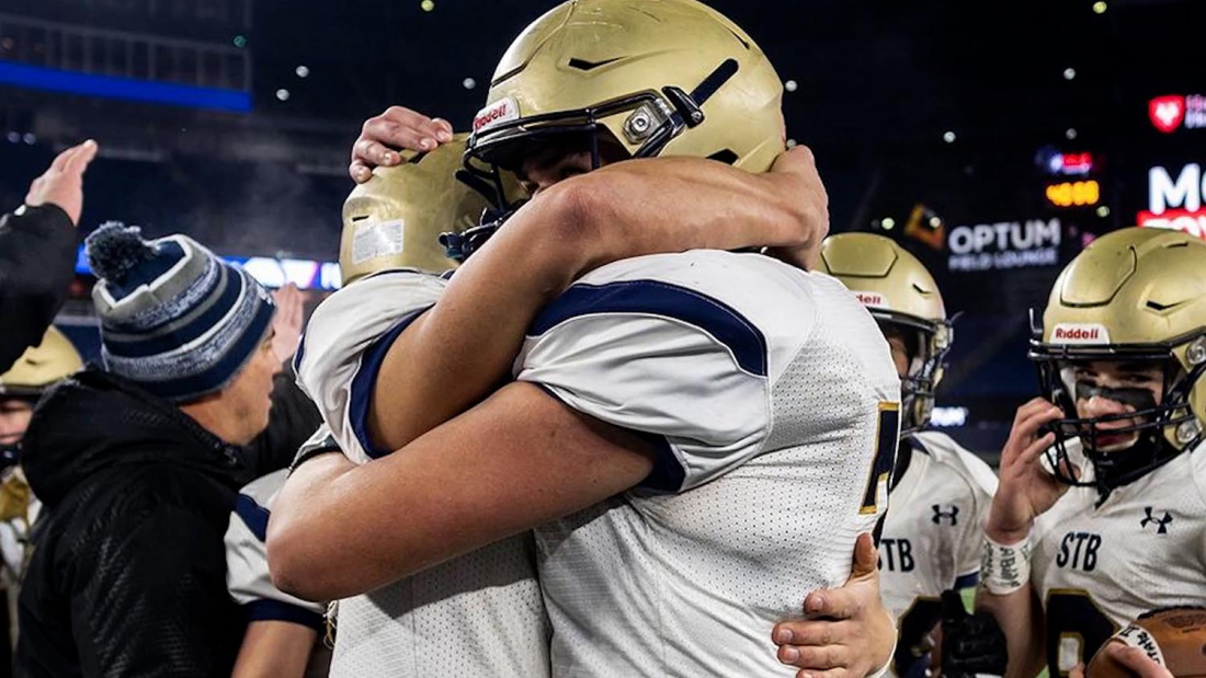 Football players embracing