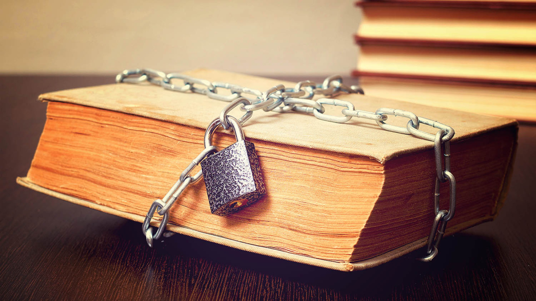 Old book bound by lock and chain