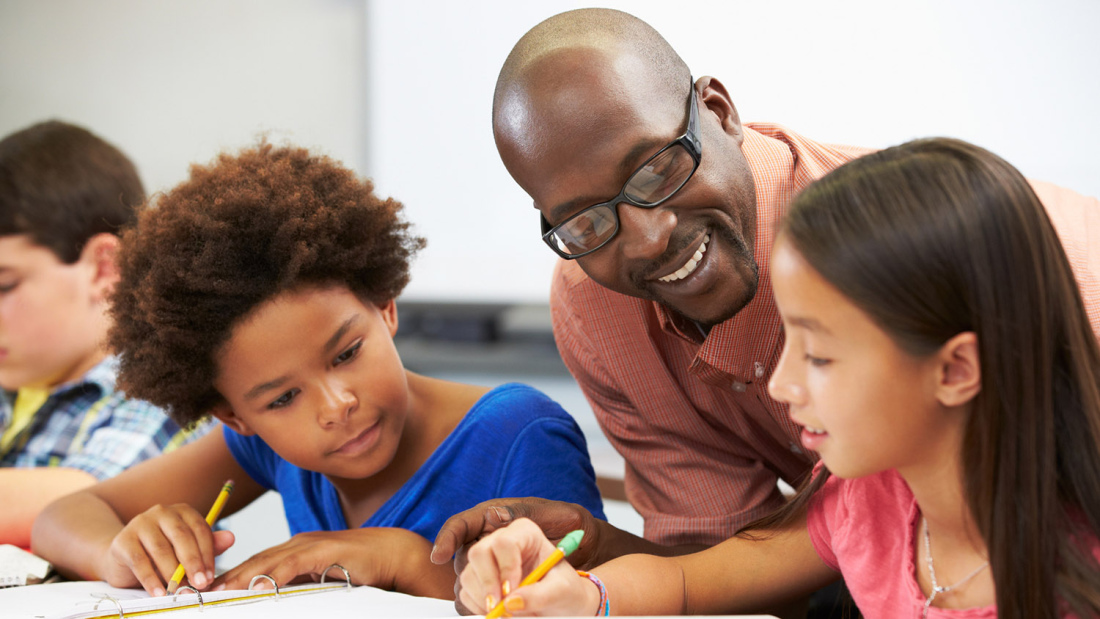 Teacher helping students