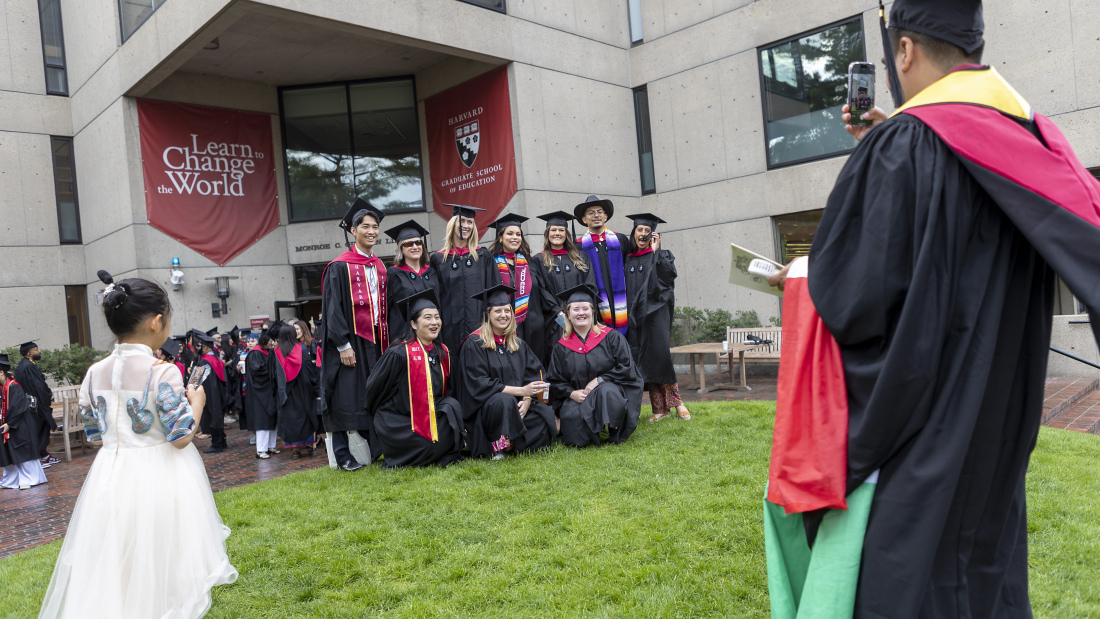 Graduates taking a photo on the hill
