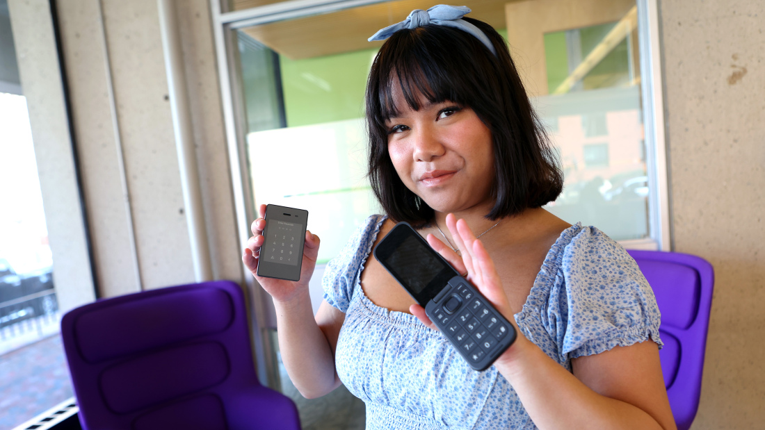 Photo of Gabriela Nguyen holding two phones