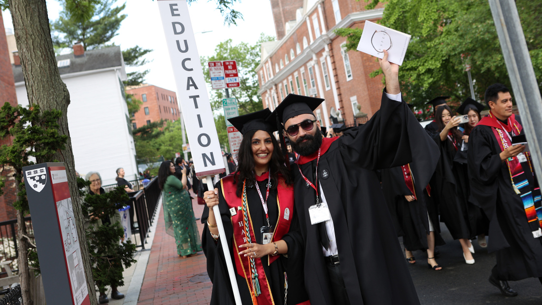 Grads holding Education sign