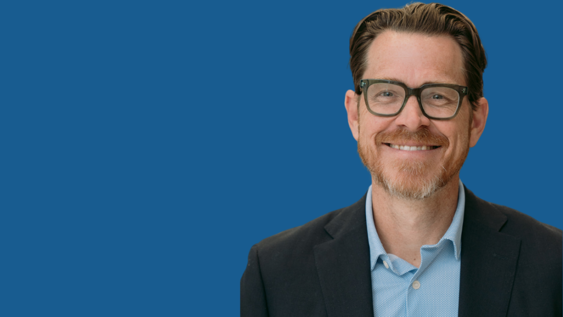 Photo of Tyler Thigpen on a blue backdrop
