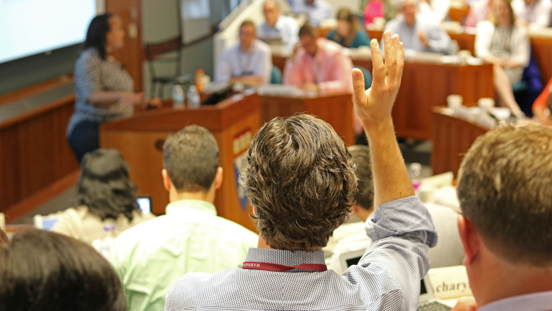 A participant raises their hand in Larsen Hall
