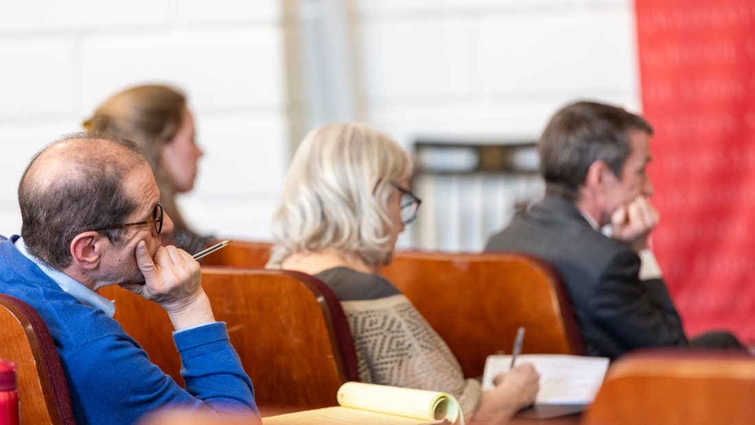 Attendees listen to the speakers