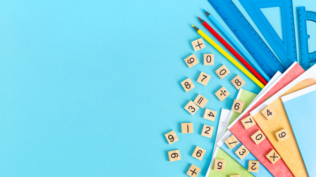 Bright multicolored school supplies, stationery on a blue background