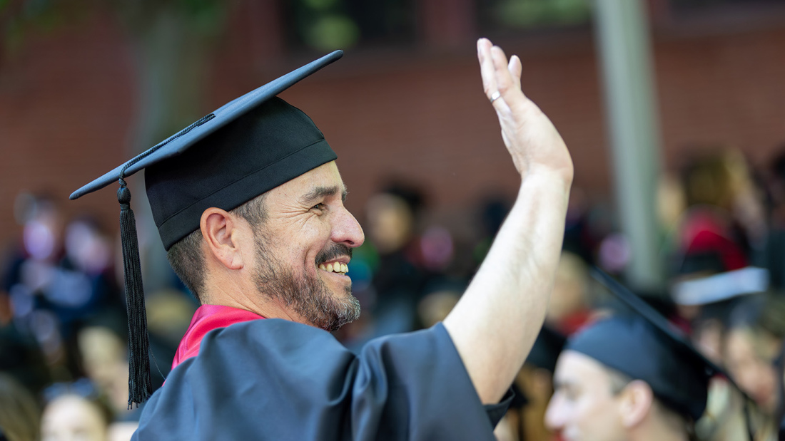 Waving graduate