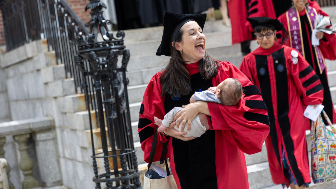 Doctoral student with her baby at the Diploma Ceremony
